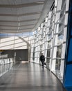 International business man in a suit walks down an empty hall in the Calgary airport Royalty Free Stock Photo