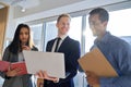 International business team people using laptop standing in office. Royalty Free Stock Photo