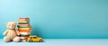 Childrens Book Day, a stack of books and a teddy bear and a toy car on a blue background, a place for text Royalty Free Stock Photo