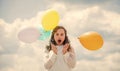 international childrens day. Happy child with colorful air balloons over blue sky background. express positive emotions Royalty Free Stock Photo