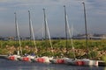 Five J/70 yachts moored in the wake against the backdrop of the shore on a sunny summer evening