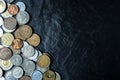 International coins background on black stone table top texture, with copy space Royalty Free Stock Photo