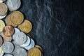 International coins background on black stone table top texture, with copy space Royalty Free Stock Photo