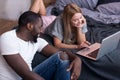 International couple using laptop in bed Royalty Free Stock Photo