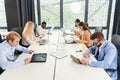 International coworkers studying different business papers and working with laptops and tablets in the modern office Royalty Free Stock Photo