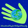 International Day for Biological Diversity. Green hand holding a Earth. Blue night background