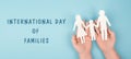 International day of families, Parents with one child holding hands, paper cut out, blue colored background, relationship Royalty Free Stock Photo