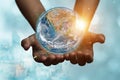 International Day of Forests and earth day concept: Hands holding blue earth globe over and green city background for World Royalty Free Stock Photo