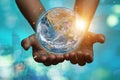 International Day of Forests and earth day concept: Hands holding blue earth globe over and green city background for World Royalty Free Stock Photo