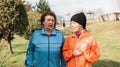 International Day of Older Persons. Portraits of happy a grandmother with an adult granddaughter walking in the park and Royalty Free Stock Photo