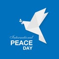 International day of peace banner with white paper dove with leaf on blue background. Vector illustration EPS10