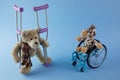 International day of persons with disabilities. Wheelchair with toys sign of different disabilities on blue background.