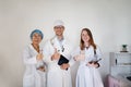 International doctor team. Hospital medical staff. Mixed race Asian and Caucasian doctor giving sign thumbs up. Royalty Free Stock Photo