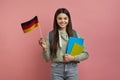 International Education. Beautiful Female Student With Backpack Holding German Flag Royalty Free Stock Photo