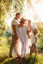 International Family Day. Young mother, father spending time with precious two child daughters in the summer park on Royalty Free Stock Photo