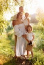 International Family Day. Young mother, father spending time with precious two child daughters in the summer park on Royalty Free Stock Photo