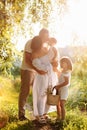 International Family Day. Young mother, father spending time with precious two child daughters in the summer park on Royalty Free Stock Photo