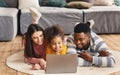 International family on the floor watching laptop