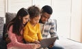 International family looking at tablet at home