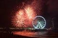 Spinning Ferris Wheel with fireworks at the pier of Scheveningen, near The Hague, Netherlands. Royalty Free Stock Photo