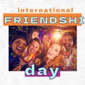 International friendshi day text over happy diverse friends at party in club