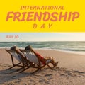 International friendship day text with diverse senior friends in deckchairs on sunny beach Royalty Free Stock Photo