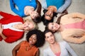 International group of happy women lying on floor