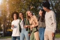 International group of teenagers laughing while walking by park Royalty Free Stock Photo