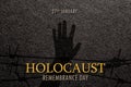 International Holocaust Remembrance Day. January 27. silhouette of hand with barber wire on black textured background.