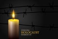 International holocaust remembrance day. Three burning candle and with barbed wire on a black background.