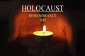 International Holocaust Remembrance Day. Woman holding burning candle in darkness, closeup Royalty Free Stock Photo