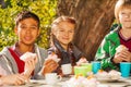 International kids drink tea with cupcakes Royalty Free Stock Photo