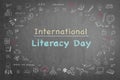 International literacy day on black chalkboard with doodle