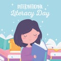 International literacy day, girl reading book and textbooks