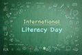 International literacy day on green chalkboard with doodle