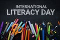 International Literacy Day. School Stationary on Blackboard Top Royalty Free Stock Photo