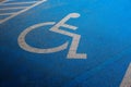 International markings for a handicapped parking, Disabled symbol sign on blue asphalt in parking space Royalty Free Stock Photo