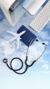 International medical travel insurance concept,stethoscope, passport, computer and airplane in sky background with global map