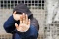 International migrants day concept: Alone victim woman standing near fence net