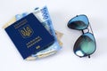 international passport of Ukraine, money and glasses on a white background. `The concept of travel without unnecessary things` Royalty Free Stock Photo