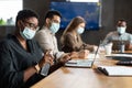 International people wearing medical masks using sanitizer