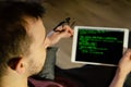 International Programmers Day. Caucasian man programs on the tablet at home. Developing programming and coding technologies. Royalty Free Stock Photo