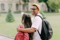 International students couple walking to the university building hugging each other, wearing stylish clothes Royalty Free Stock Photo