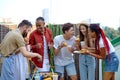 International Students eating burgers and drinking lemonade at barbecue patio party