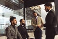 An international team of successful young business men in suits at a meeting are discussing the implementation of Royalty Free Stock Photo