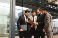 An international team of successful young business men in suits at a meeting are discussing the implementation of Royalty Free Stock Photo