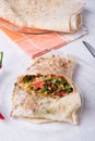 International vegetarian  shawarma sandwich roll with vegetable and greens. served at white table. arabian and caucaisian cuisine Royalty Free Stock Photo