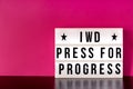 International Women`s Day - concept - `Press for Progress` 2018 theme - light box with cinema style lettering on hot pink backgrou