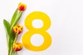 International Women's Day greeting card. 8 March concept. Tulip on yellow number eight on white background. Copy