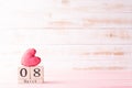 International Womens day concept. March 8 text on wooden block with handmade pink heart on white wooden background Royalty Free Stock Photo